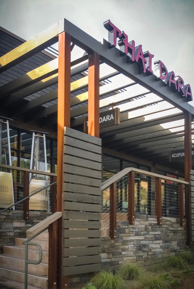 Covered trellis walkway leading to the restaurant entrances